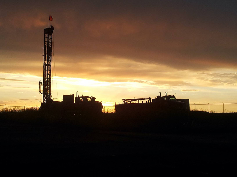 Shot of water well rigs at sunset